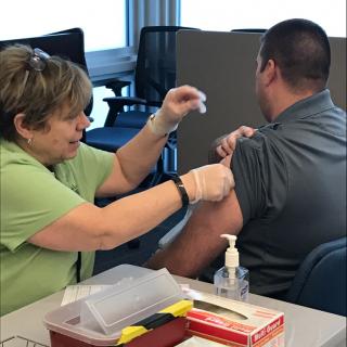 A Public Health Nurse from the St. Louis County Health Department Administers a Tetanus Vaccine.