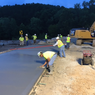 Workers pour a new lane on Route T in Wayne County